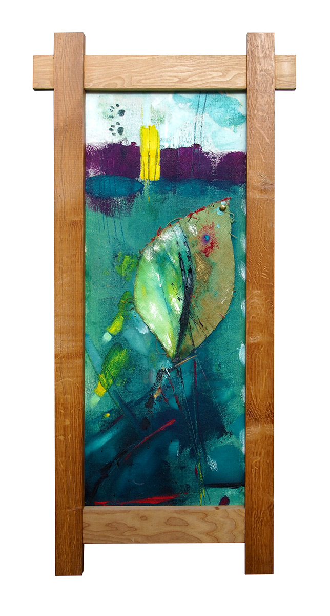 a big leaf, cats paw print and landscape in a wooden frame